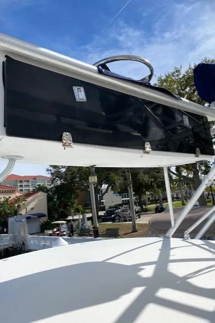 Slide: The Image of 2000 Cabo 35 Express boat with black storage compartment and steering wheel. - 38