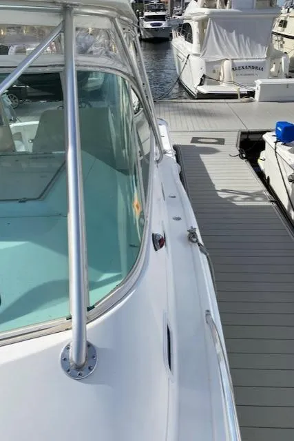 Slide: The Image of 2000 Cabo 35 Express boat docked at a marina. - 42