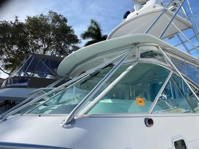 Slide: The Image of 2000 Cabo 35 Express boat with sleek design and clear windows. - 9