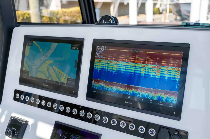 Slide: The Image of Control panel of 2026 Reef Runner 340 boat with Garmin navigation displays. - 10