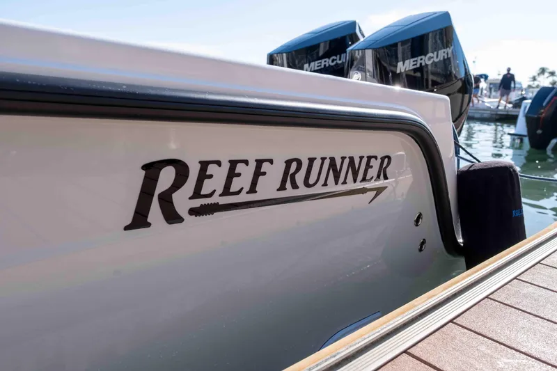 Slide: The Image of 2026 Reef Runner 340 boat with Mercury engines docked at marina. - 5