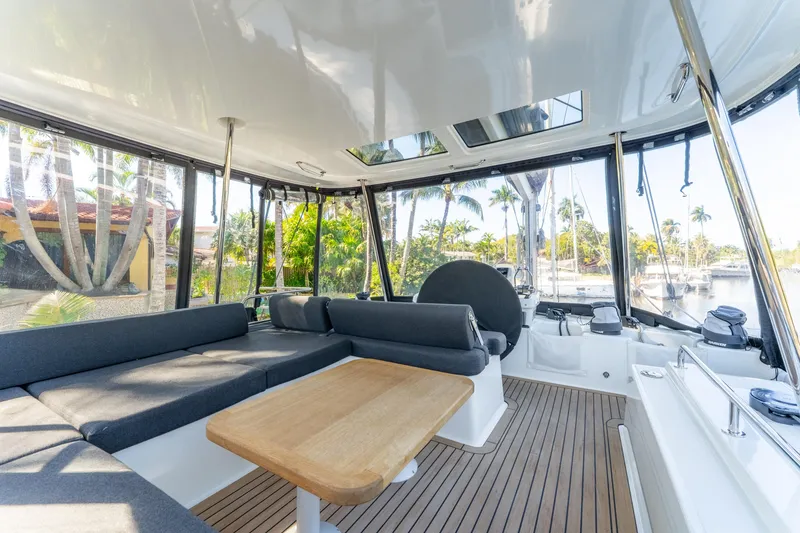 Slide: The Image of Luxurious 2024 Lagoon 51 yacht interior with spacious seating and scenic marina view. - 18