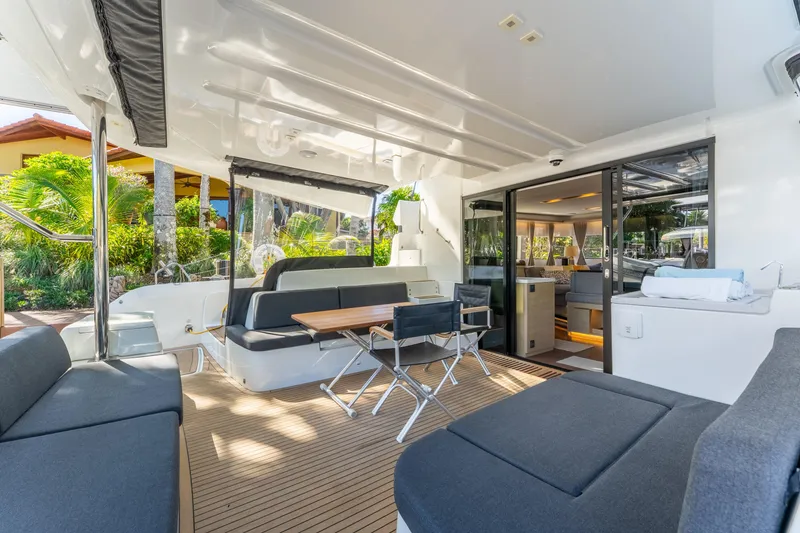 Slide: The Image of Luxurious 2024 Lagoon 51 yacht interior with modern seating and dining area. - 23