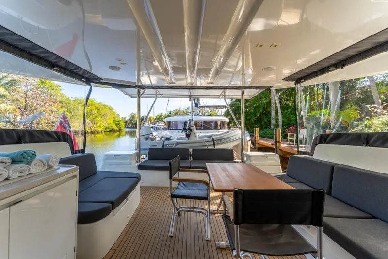 Slide: The Image of Luxurious 2024 Lagoon 51 yacht interior with seating, table, and scenic waterway view. - 28