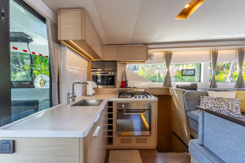Slide: The Image of Modern interior of 2024 Lagoon 51 yacht with sleek kitchen and cozy seating area. - 38
