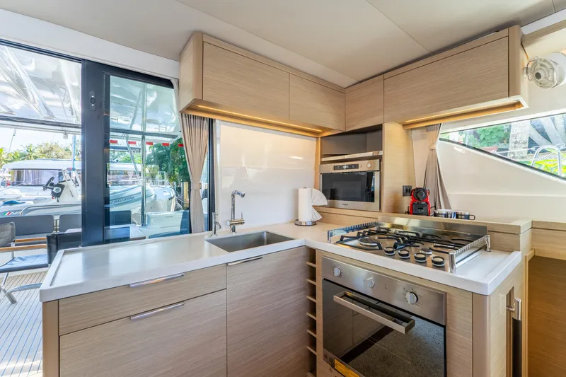 Slide: The Image of Modern kitchen interior of 2024 Lagoon 51 yacht with stove and sleek cabinetry. - 39