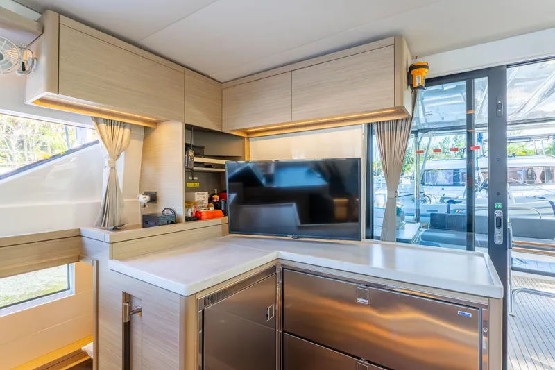 Slide: The Image of Modern interior of 2024 Lagoon 51 yacht with sleek kitchen and large windows. - 41