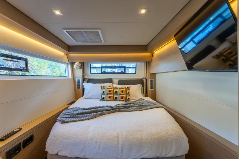 Slide: The Image of Luxurious bedroom interior of 2024 Lagoon 51 yacht with modern decor and cozy bedding. - 47