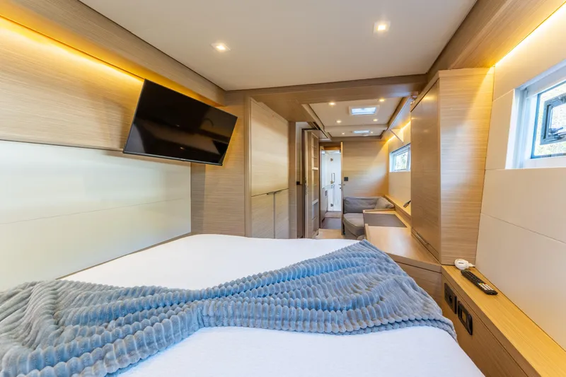 Slide: The Image of Luxurious interior of 2024 Lagoon 51 yacht with modern amenities and cozy bedding. - 48