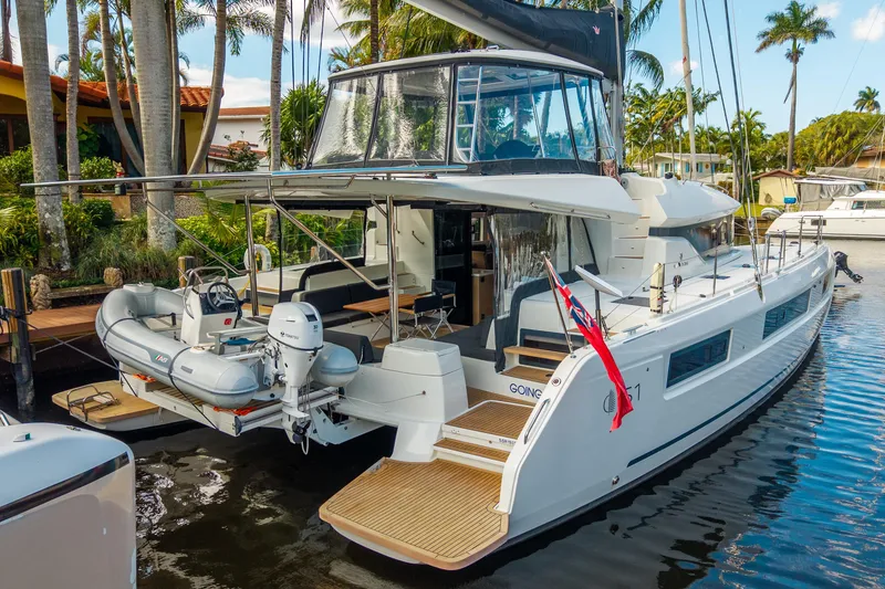 Slide: The Image of 2024 Lagoon 51 yacht docked, featuring spacious deck and modern design. - 5