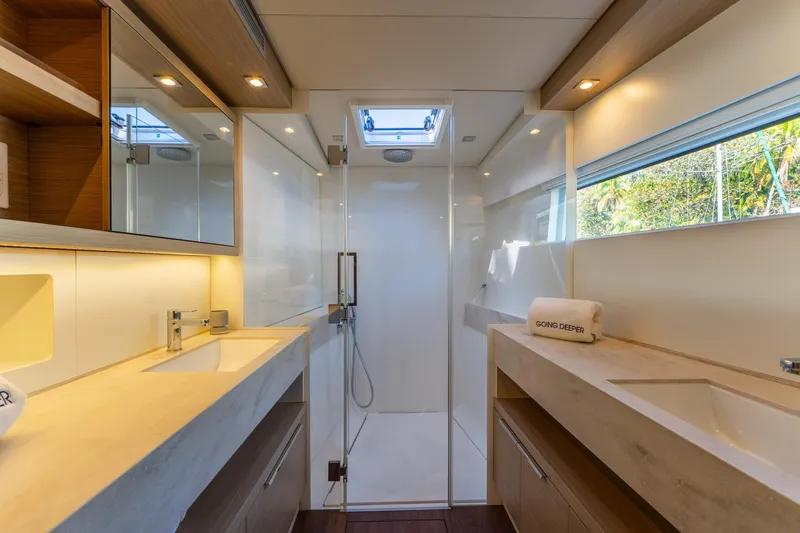 Slide: The Image of Luxurious bathroom in 2024 Lagoon 51 yacht, featuring dual sinks and modern shower. - 52