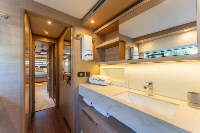 Slide: The Image of Luxurious interior of 2024 Lagoon 51 yacht, featuring modern bathroom and cozy bedroom. - 53