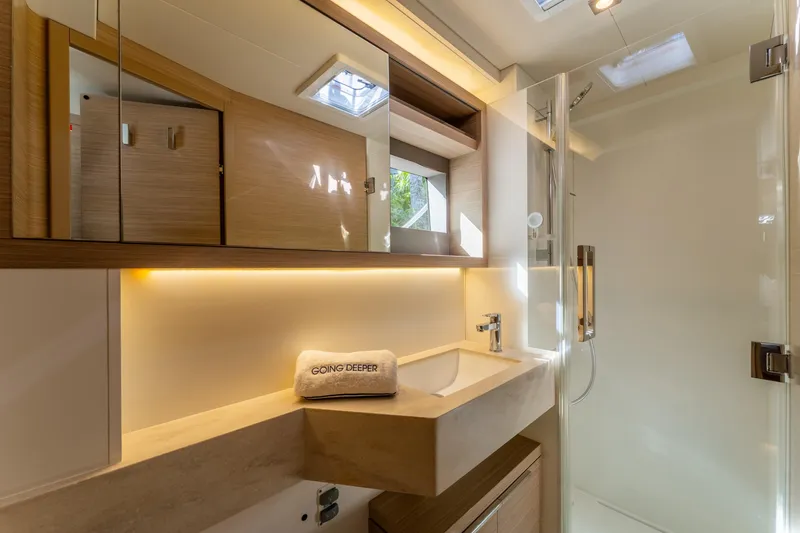 Slide: The Image of Luxurious bathroom in 2024 Lagoon 51 yacht, featuring modern fixtures and elegant lighting. - 54