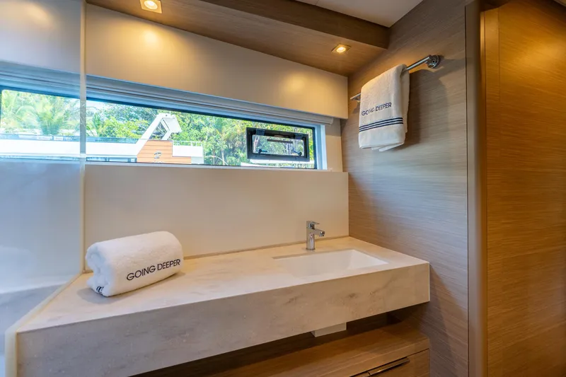 Slide: The Image of Luxurious bathroom in 2024 Lagoon 51 yacht with modern sink and window view. - 55
