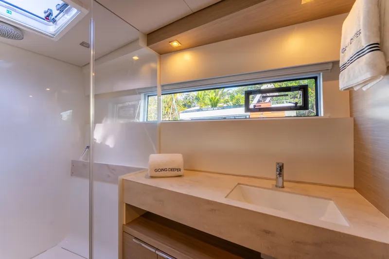 Slide: The Image of Luxurious bathroom interior of 2024 Lagoon 51 yacht with modern fixtures and natural lighting. - 56