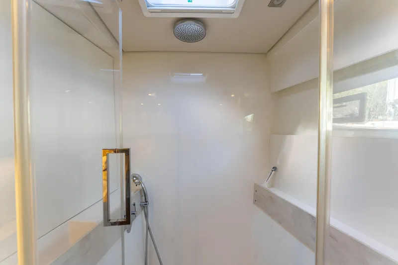 Slide: The Image of Modern shower interior in 2024 Lagoon 51 yacht, featuring sleek design and glass door. - 57