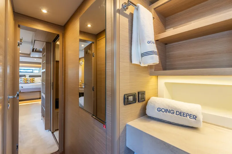 Slide: The Image of Luxurious interior of 2024 Lagoon 51 yacht with elegant wood finishes and plush towels. - 59