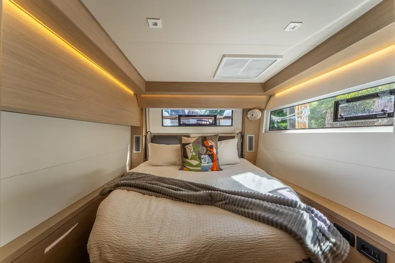 Slide: The Image of Luxurious cabin interior of 2024 Lagoon 51 yacht with modern design and cozy bedding. - 63