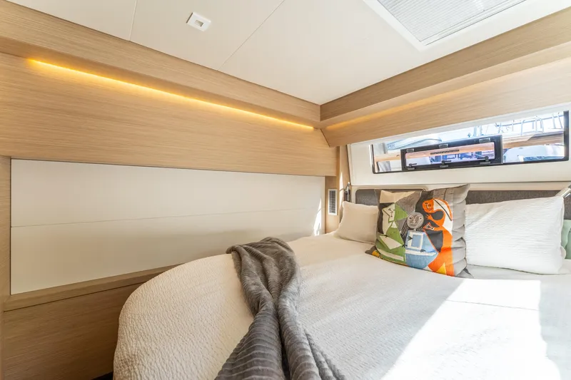 Slide: The Image of Luxurious 2024 Lagoon 51 yacht bedroom with modern design and cozy bedding. - 64