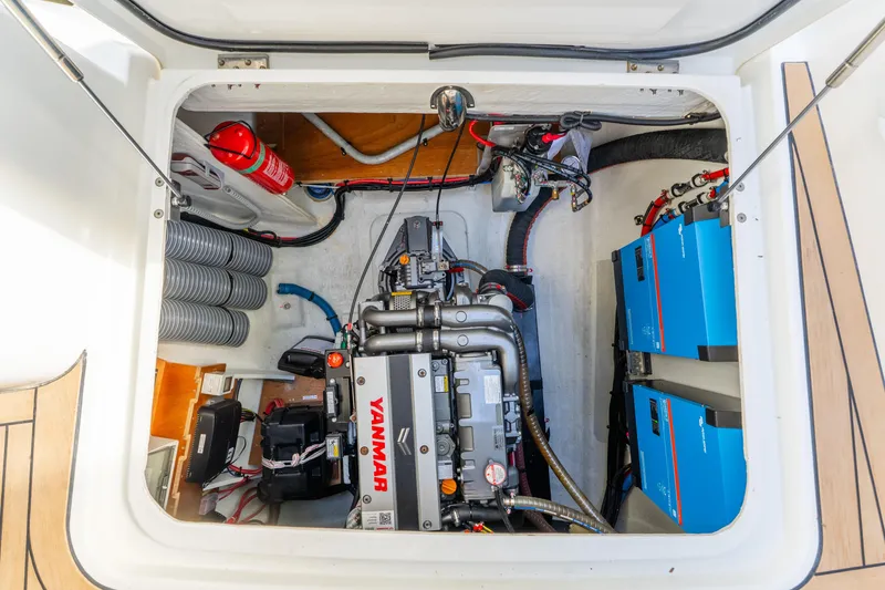 Slide: The Image of Engine compartment of 2024 Lagoon 51 yacht with Yanmar engine and electrical components. - 75