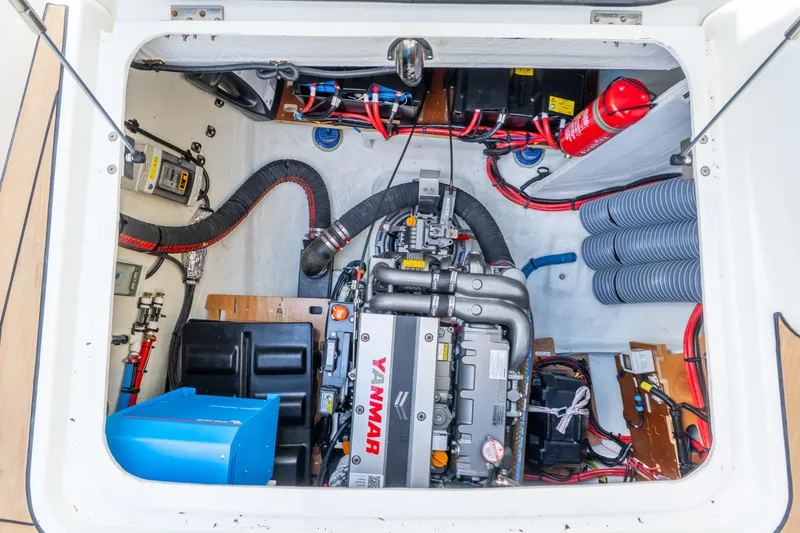 Slide: The Image of Engine compartment of 2024 Lagoon 51 yacht, featuring Yanmar engine and organized wiring. - 76