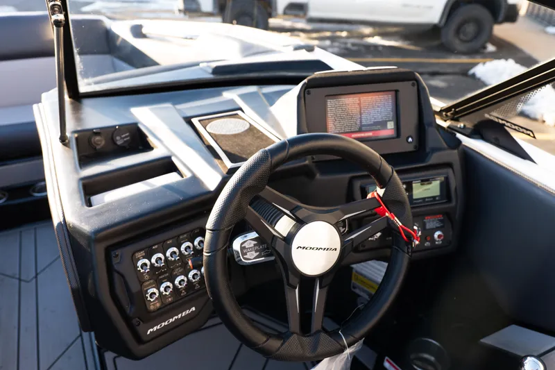 Slide: The Image of 2021 Moomba Mondo boat dashboard with steering wheel and control panel. - 14