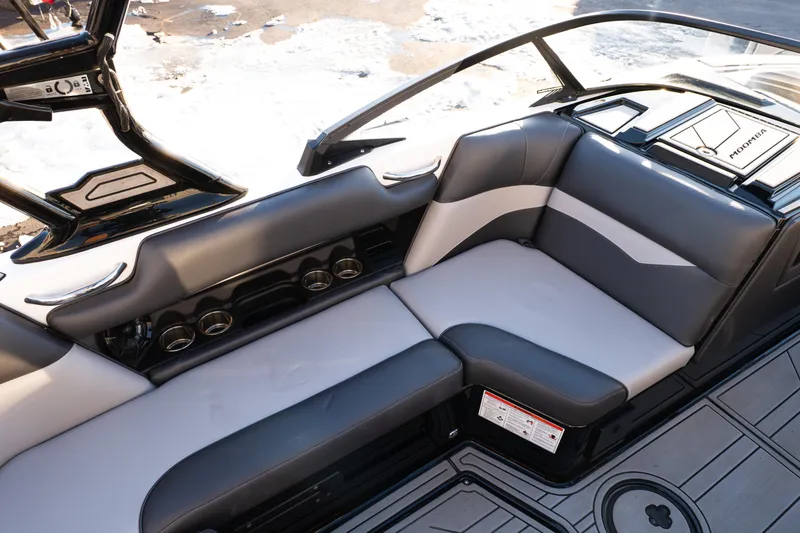 Slide: The Image of 2021 Moomba Mondo boat interior with sleek gray seating and cup holders. - 16