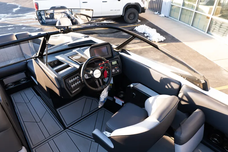 Slide: The Image of 2021 Moomba Mondo boat interior with steering wheel and dashboard controls. - 17
