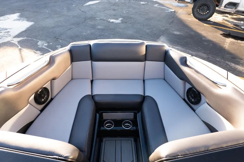 Slide: The Image of 2021 Moomba Mondo boat interior with cushioned seating and cup holders. - 18