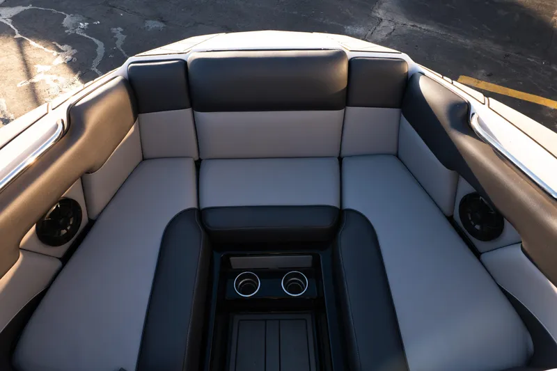 Slide: The Image of 2021 Moomba Mondo boat interior with cushioned seating and cup holders. - 19