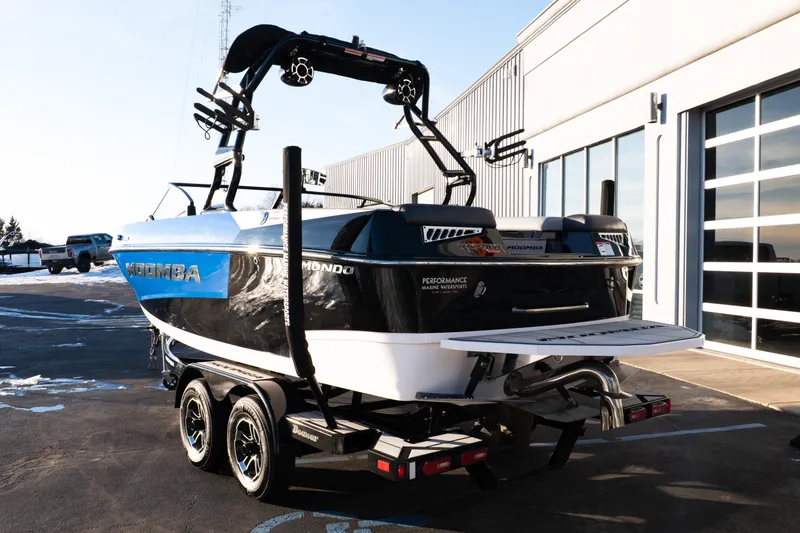 Slide: The Image of 2021 Moomba Mondo boat on trailer, parked outside a modern building. - 3