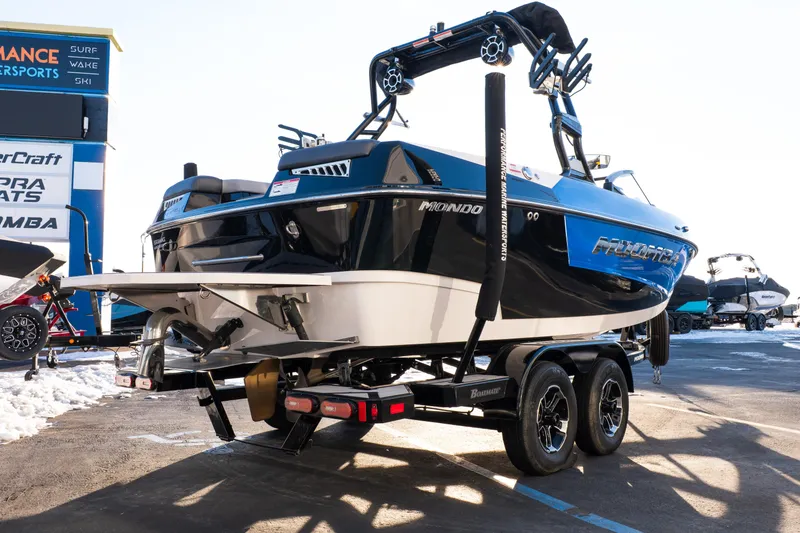 Slide: The Image of 2021 Moomba Mondo boat on trailer at dealership, showcasing sleek design and vibrant colors. - 5