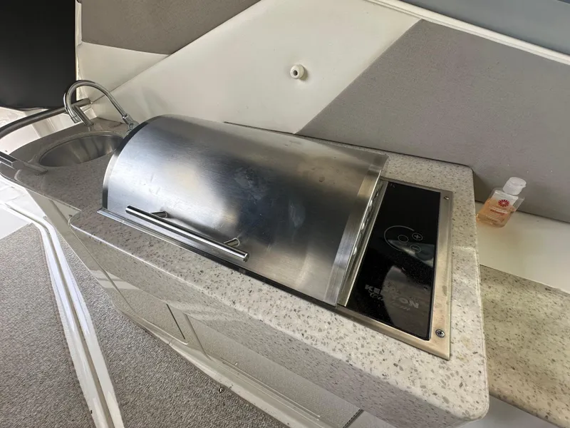 Slide: The Image of 2008 Sea Ray Sundancer 310 boat kitchen area with sink and grill. - 10