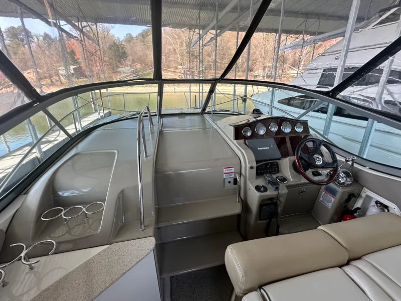 Slide: The Image of 2008 Sea Ray Sundancer 310 cockpit with steering wheel and seating. - 12