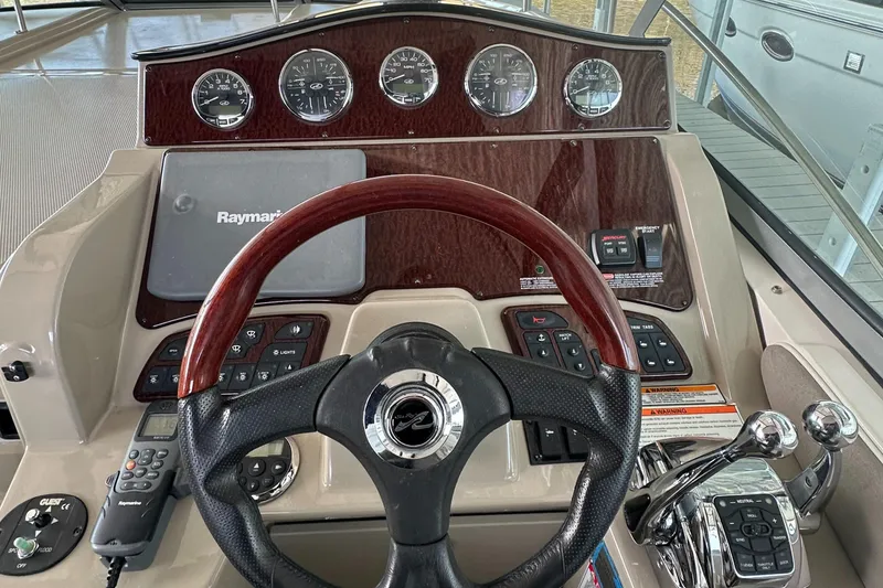 Slide: The Image of 2008 Sea Ray Sundancer 310 helm with wood paneling. - 16