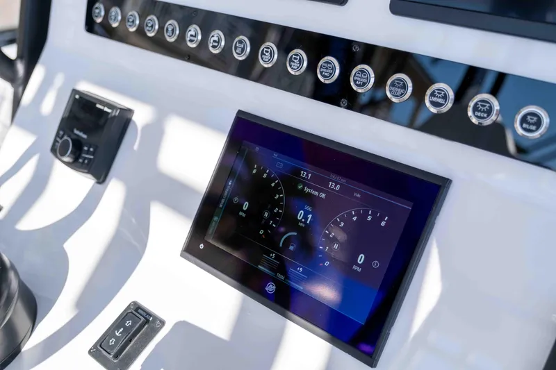 Slide: The Image of Reef Runner 340 2026 boat console with digital display and controls. - 11