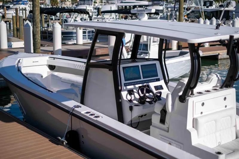Slide: The Image of Reef Runner 340 boat 2026 at dock with modern helm console. - 6