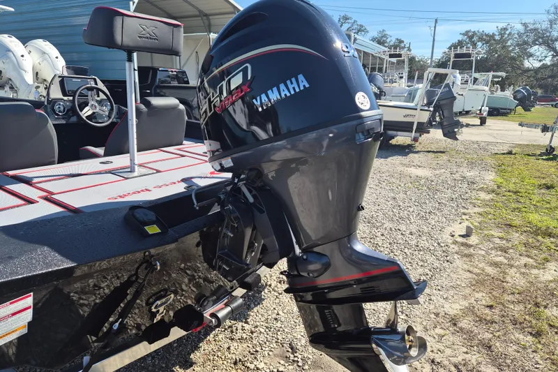 Slide: The Image of 2026 Xpress H20B Bay boat with Yamaha outboard motor in a sunny outdoor setting. - 3