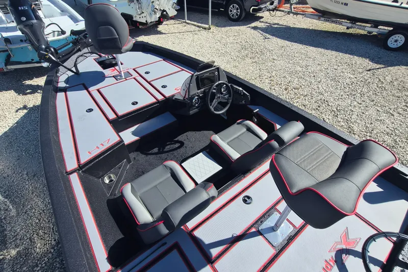 Slide: The Image of 2026 Xpress H20B Bay boat interior with modern seating and steering console. - 4