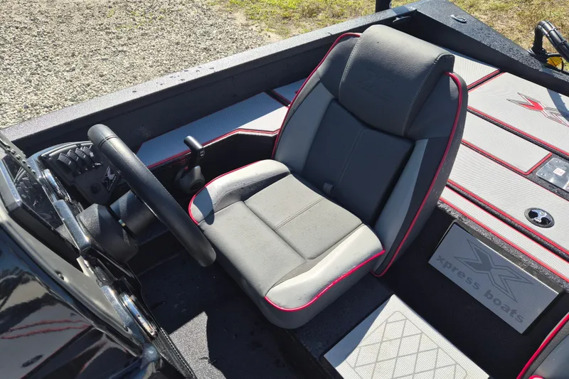 Slide: The Image of 2026 Xpress H20B Bay boat interior with steering wheel and cushioned seat. - 6