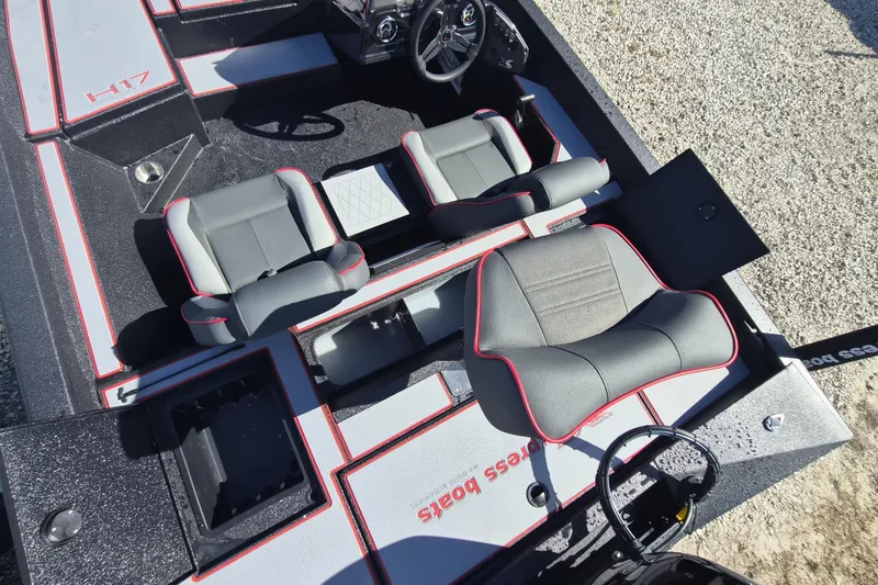 Slide: The Image of 2026 Xpress H20B Bay boat interior with gray and red seating, steering wheel, and storage compartments. - 9