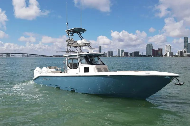 Slide: The Image of Manufacturer Provided Image: 2026 Solace 37 PILOT boat cruising in urban waterfront setting. - 0