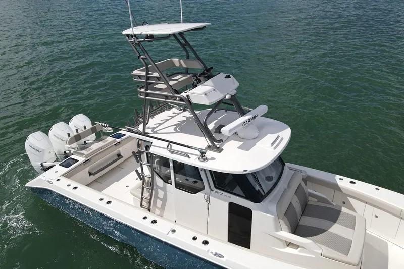 Slide: The Image of Manufacturer Provided Image: 2026 Solace 37 PILOT boat with triple outboard engines on water. - 2