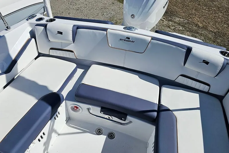 Slide: The Image of 2026 Stingray 20 SBX boat interior with white and blue seating arrangement. - 11