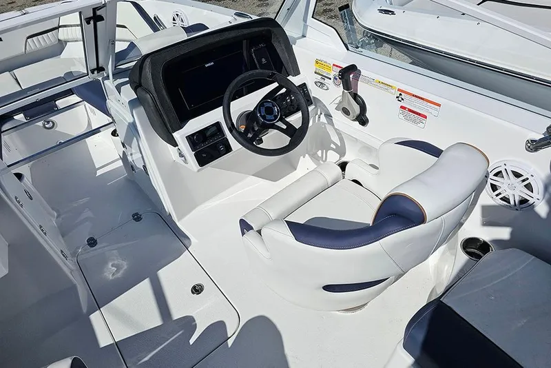 Slide: The Image of 2026 Stingray 20 SBX boat interior with modern steering and white seating. - 16