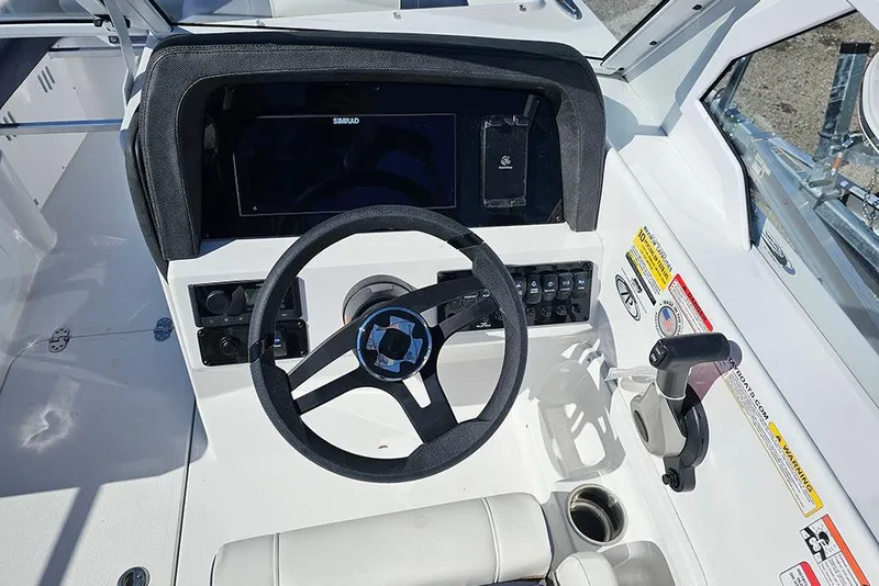 Slide: The Image of 2026 Stingray 20 SBX boat dashboard with steering wheel and control panel. - 18