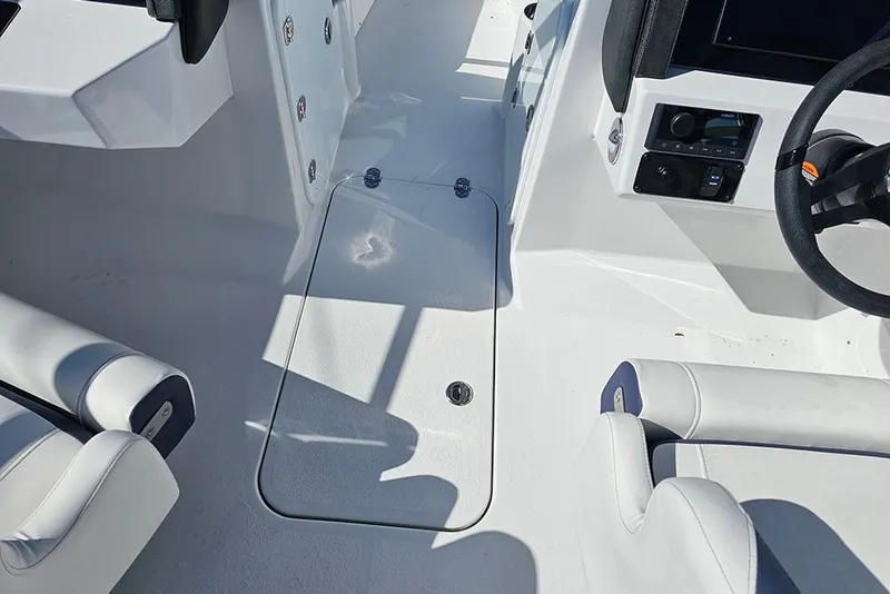 Slide: The Image of 2026 Stingray 20 SBX boat interior with white seating and control panel. - 19
