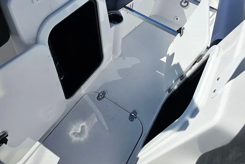 Slide: The Image of 2026 Stingray 20 SBX boat interior with open storage compartments and white flooring. - 22