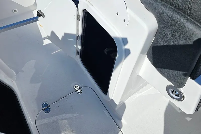 Slide: The Image of Open storage compartment on 2026 Stingray 20 SBX boat interior. - 23