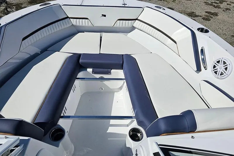 Slide: The Image of 2026 Stingray 20 SBX boat interior with white and navy seating, cup holders, and speaker. - 24